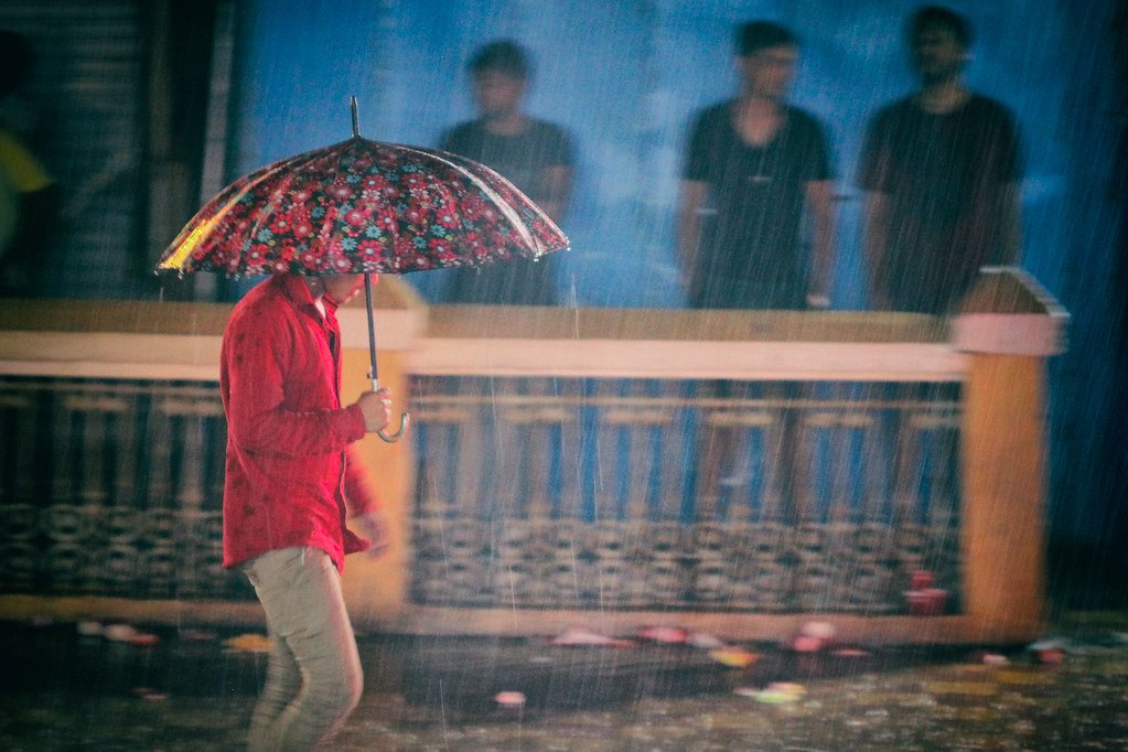 Woman walking with an umbrella during heavy rain
